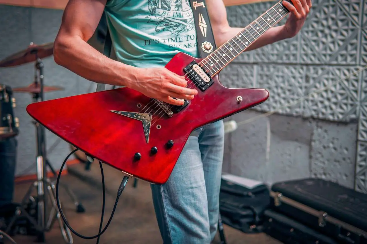 How Much Guitar Practice Is Too Much - man playing re gibson explorer