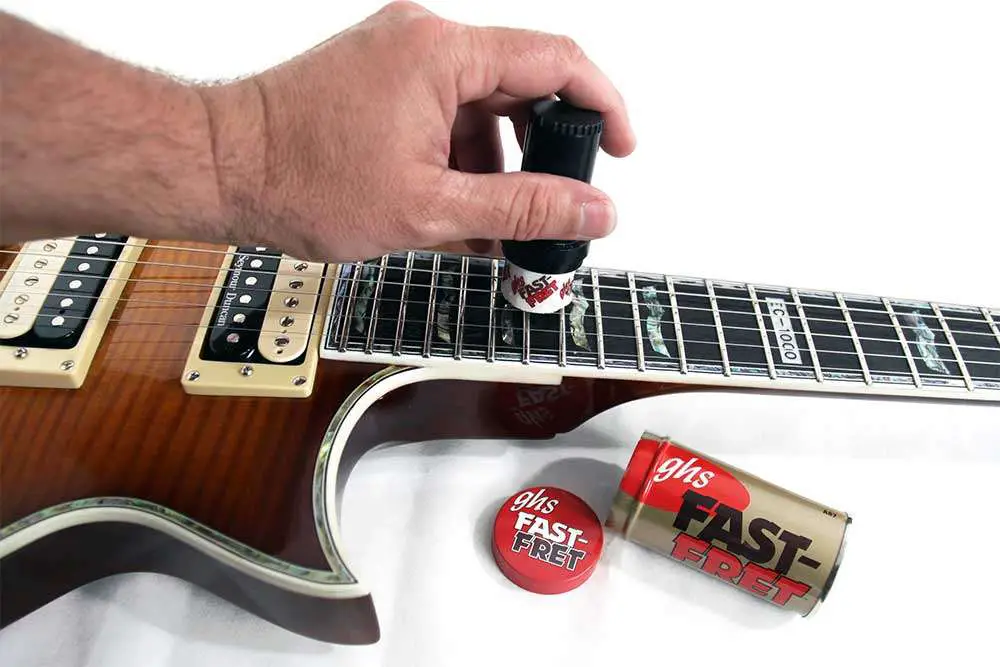 ghs fast fret being applied to a gibson les paul electric guitar