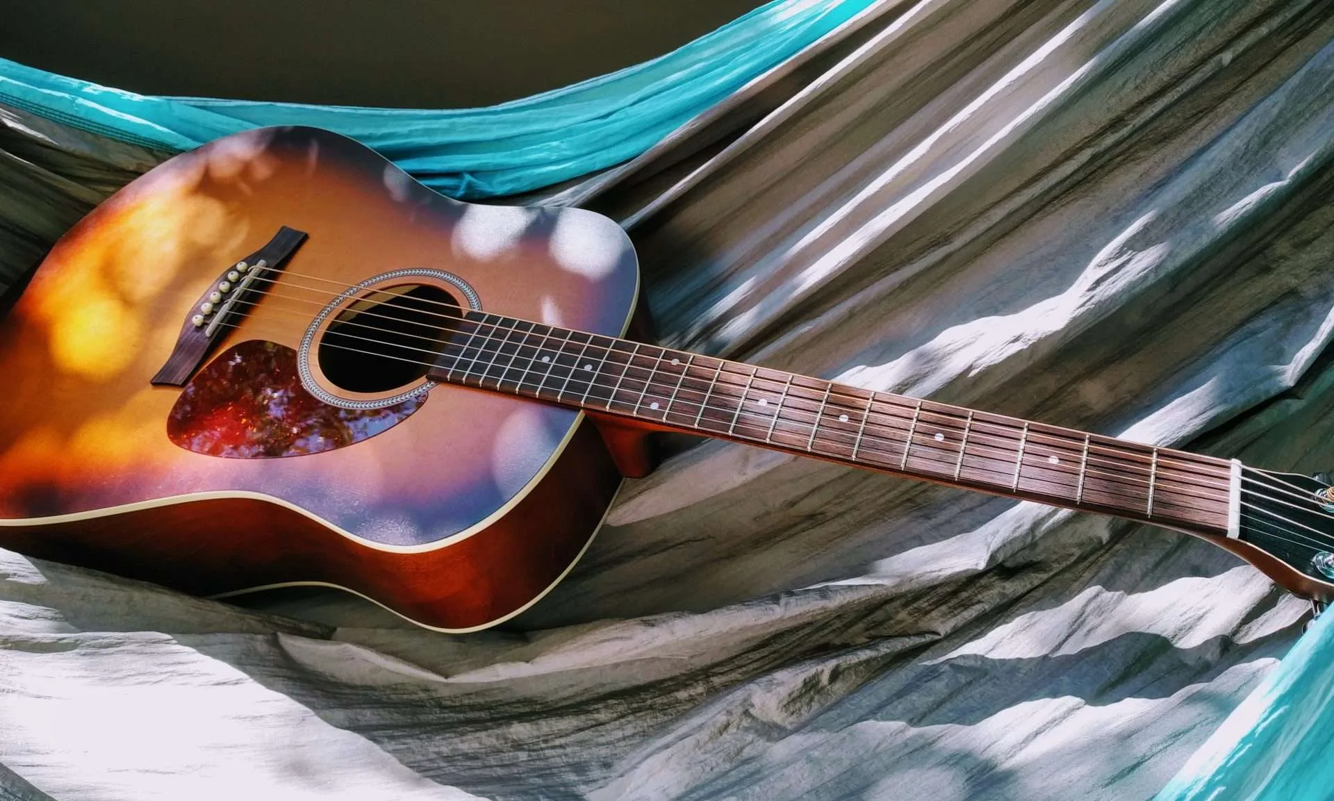 a guitar sitting on some sheets