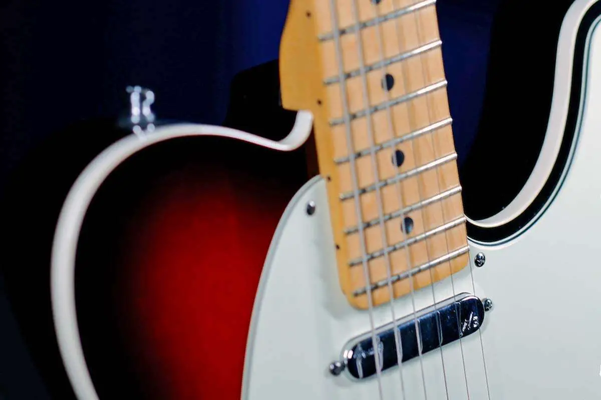 A Telecaster body, with a length of 12.75 inches and a width of 12.5 inches. The body has a classic single-cutaway shape and a sleek, glossy finish